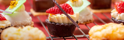 Various bite-sized Joel's Place pastries neatly arranged on a wire cooling tray