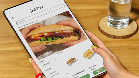 A person browsing the Click and Collect section of Joel's Place website on a tablet