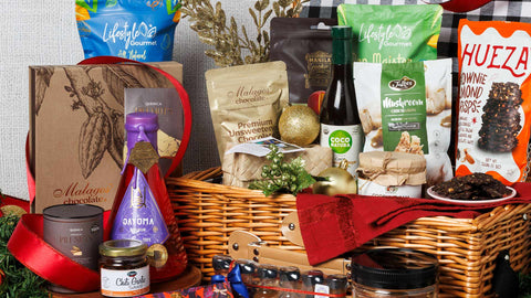 Joel’s Place Christmas Hamper featuring Filipino-made products arranged in a picnic basket, decorated with Christmas ornaments