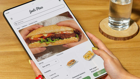 A person browsing the Click and Collect section of Joel's Place website on a tablet device