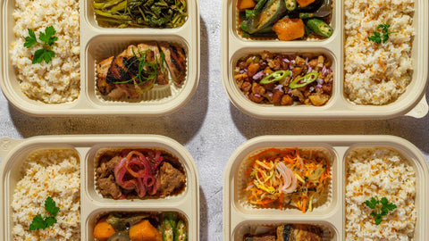 A styled image showing Joel's Place lunch sets including pork sisig, bistek, and chicken inasal on separate dishes, arranged on a marbled surface.
