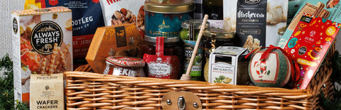 An image of Joel's Place Christmas Hampers featuring variety of curated products placed on a picnic basket