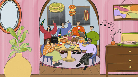 An illustration of a home with pink walls, a large potted plant on the left with a mirror hanging on top, a vinyl playing and a reed diffuser on the ride side, and an arch in the middle leading towards the dining area with people having fun and hanging out on the table filled with foods like cake, pizza, chicken wings, two candy bowls, and a take out bag of Joel's Place. 
