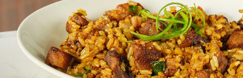 A plate of Joel's Place steak rice on a white countertop