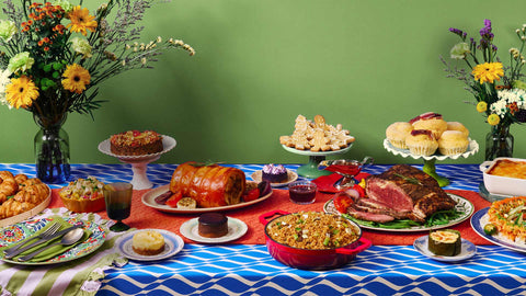 Joy at the Table Christmas 2026 Catalog cover featuring Joel's Place platters against a light green background and placed on a table with blue and white wave-patterned table cloth. 