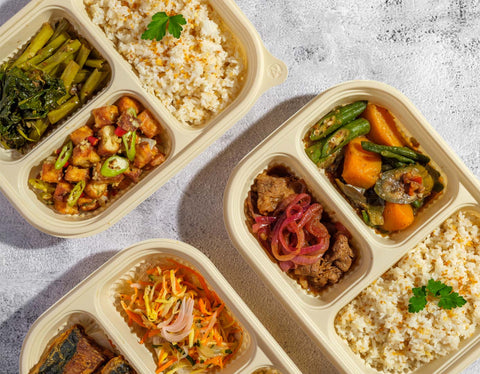 Healthy ready-to-eat-meal sets at Joel's Place packaged in a beige compartmented containers which includes, one main dish, one veggie side dish, and garlic rice